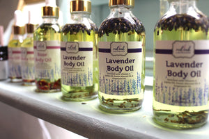 lavender and rose body oil bottles on shelf
